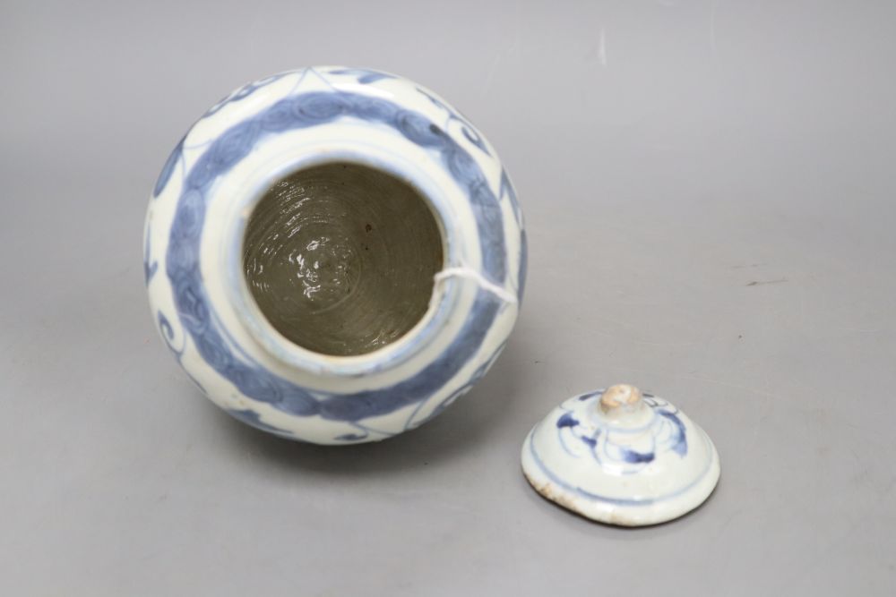 A Chinese Late Ming blue and white lion and lotus jar and cover, overall height 17.5cm, restored rim